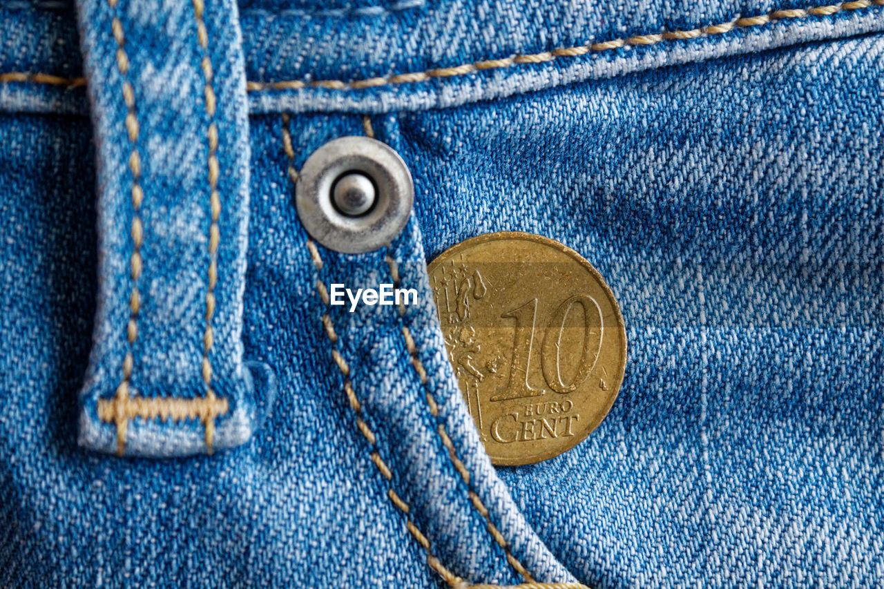 Close-up of coin in jeans pocket