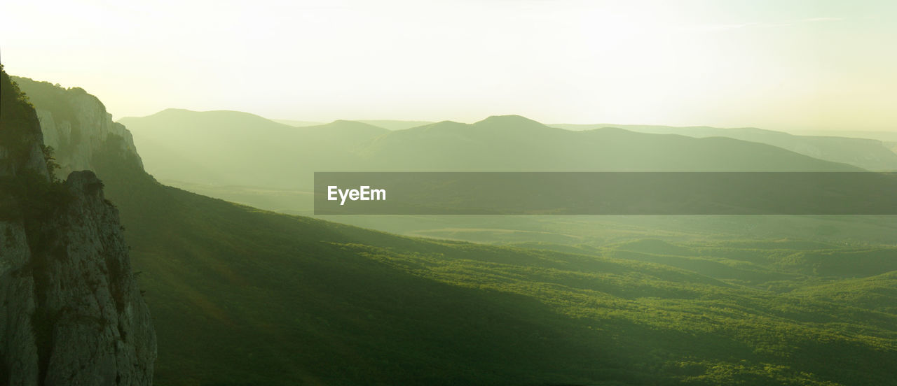 A landscape with foggy mountains silhouettes at morning sunrise. crimean peninsula, sidam qaya