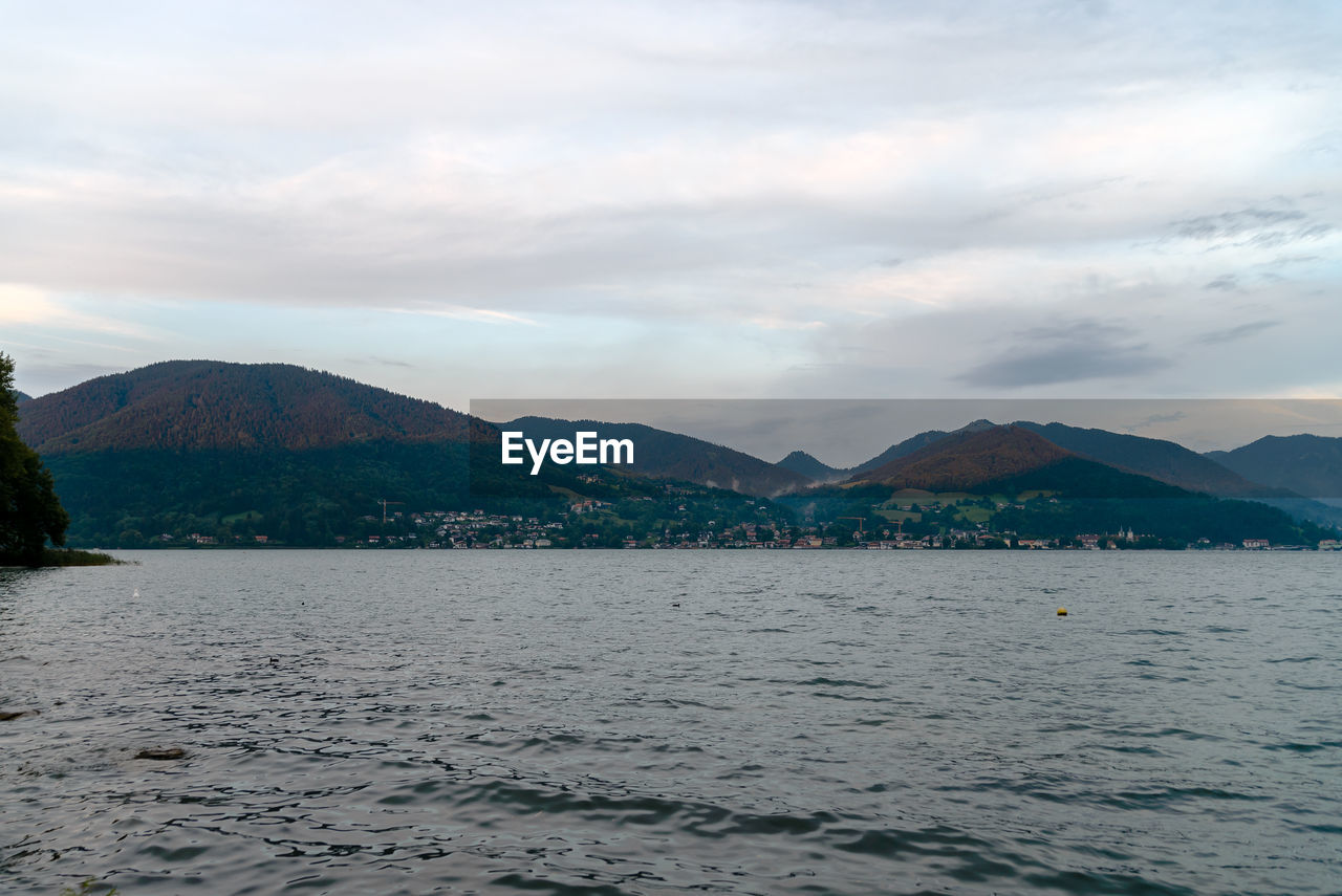 Scenic view of sea and mountains against sky