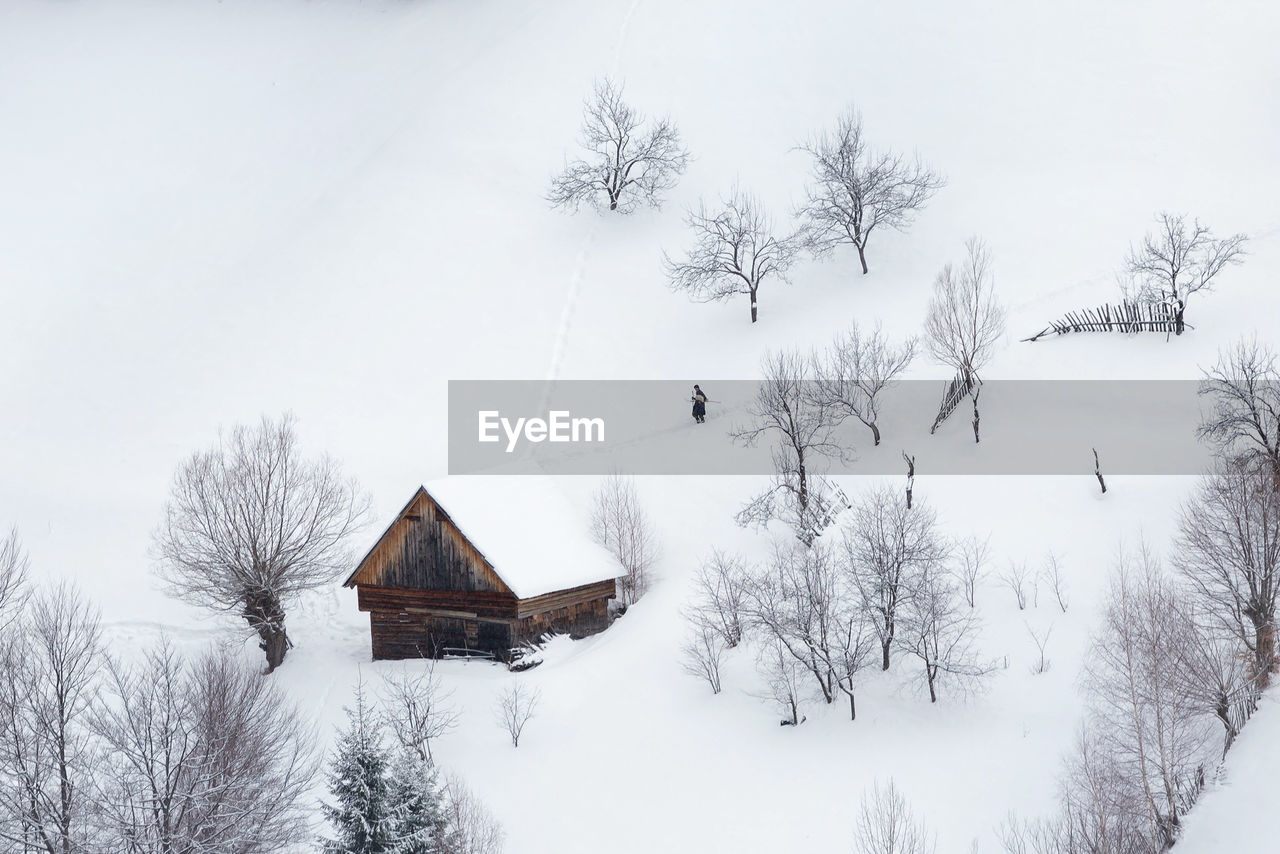 Built structure and trees against sky during winter