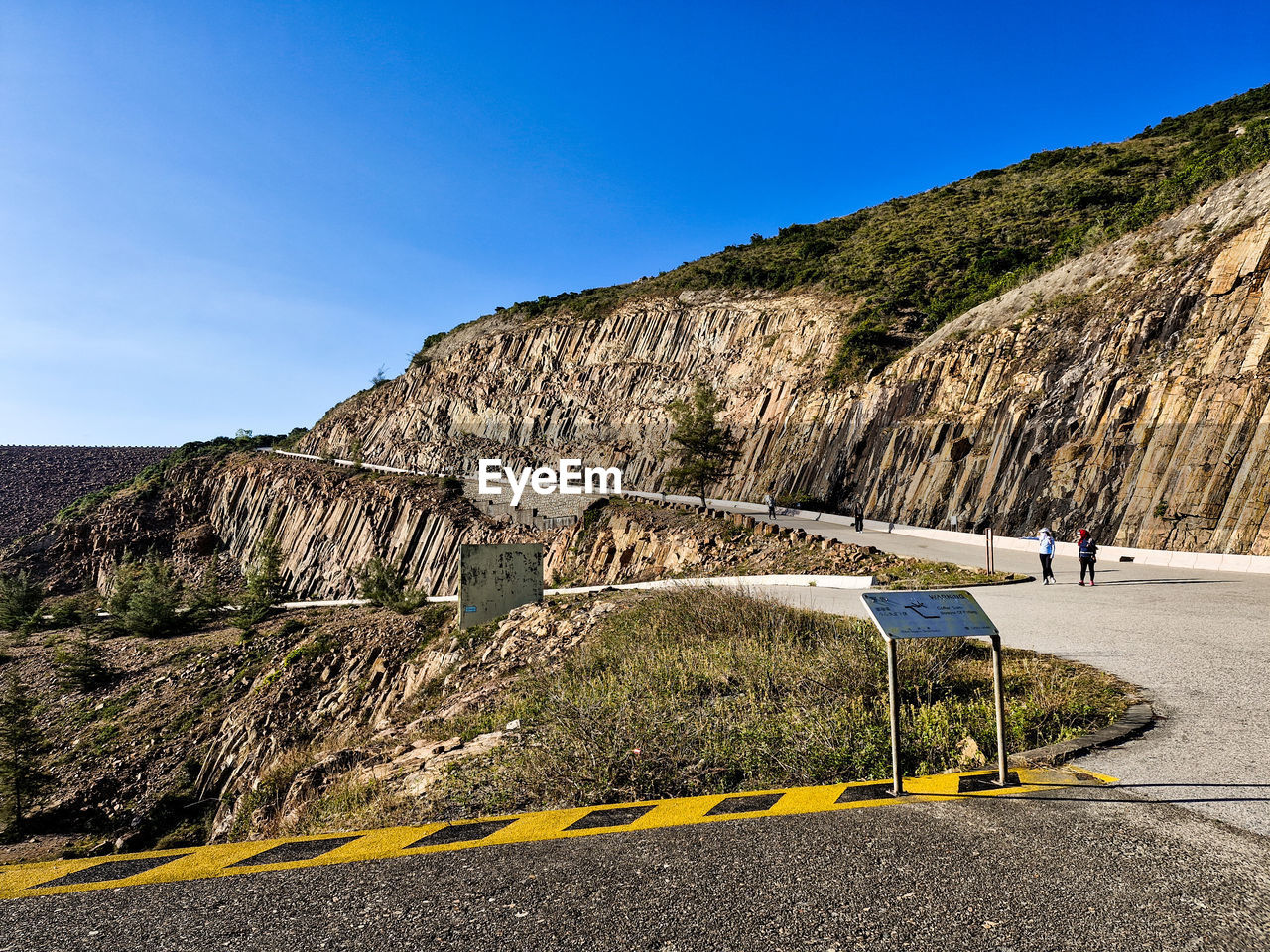 sky, road, nature, mountain, transportation, rock, cliff, clear sky, terrain, landscape, day, coast, blue, land, scenics - nature, travel, environment, outdoors, no people, sea, travel destinations, beauty in nature, sunny, plant, non-urban scene, mountain range, sunlight, mode of transportation, tranquility, geology, tourism