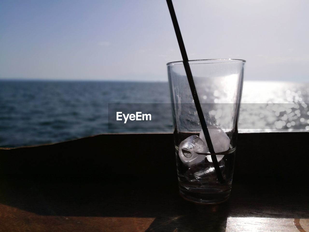 CLOSE-UP OF WATER ON TABLE AGAINST SKY