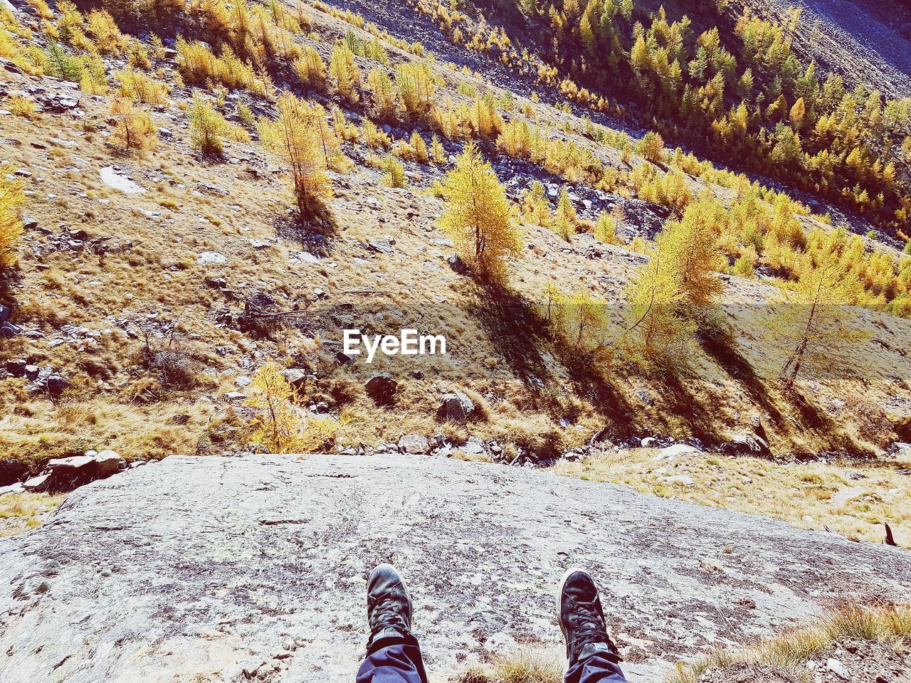 LOW SECTION OF MAN STANDING ON MOUNTAIN