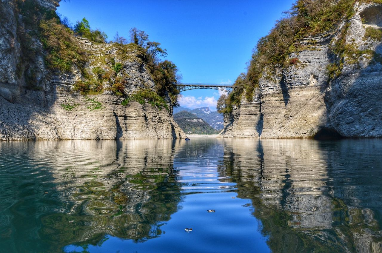 River amidst trees against clear blue sky