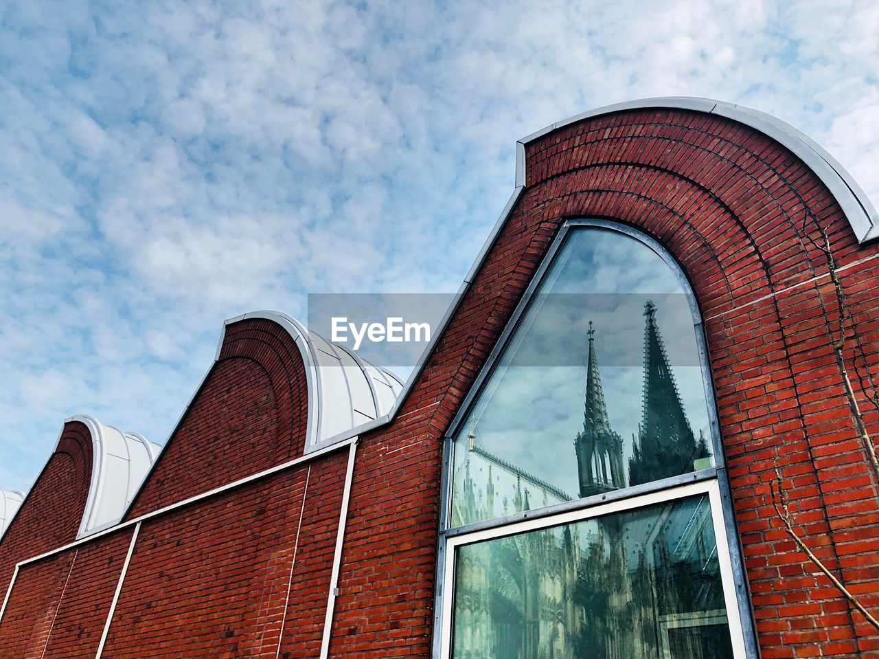 Low angle view of building against cloudy sky