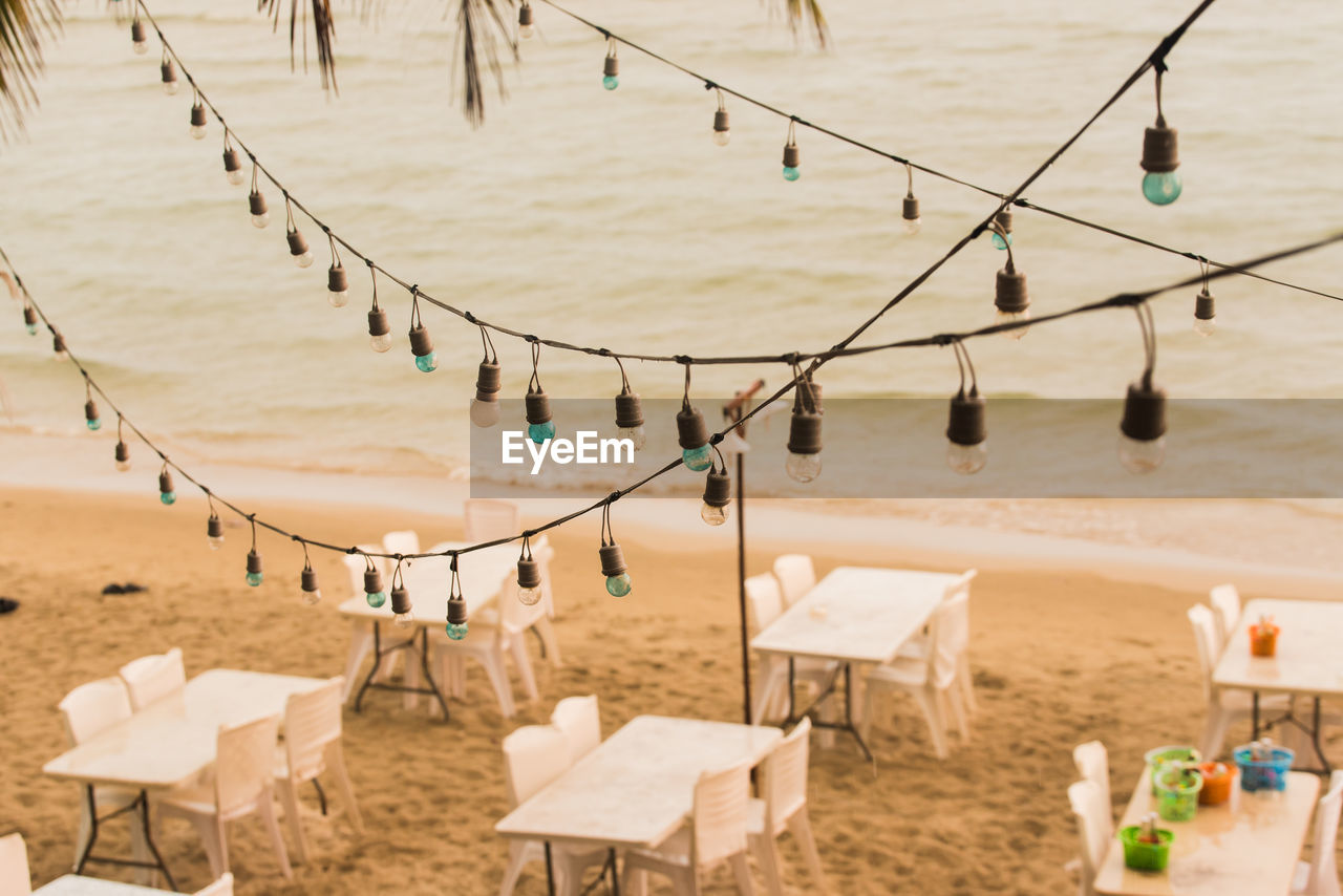 High angle view of lighting decoration hanging over cafe at beach