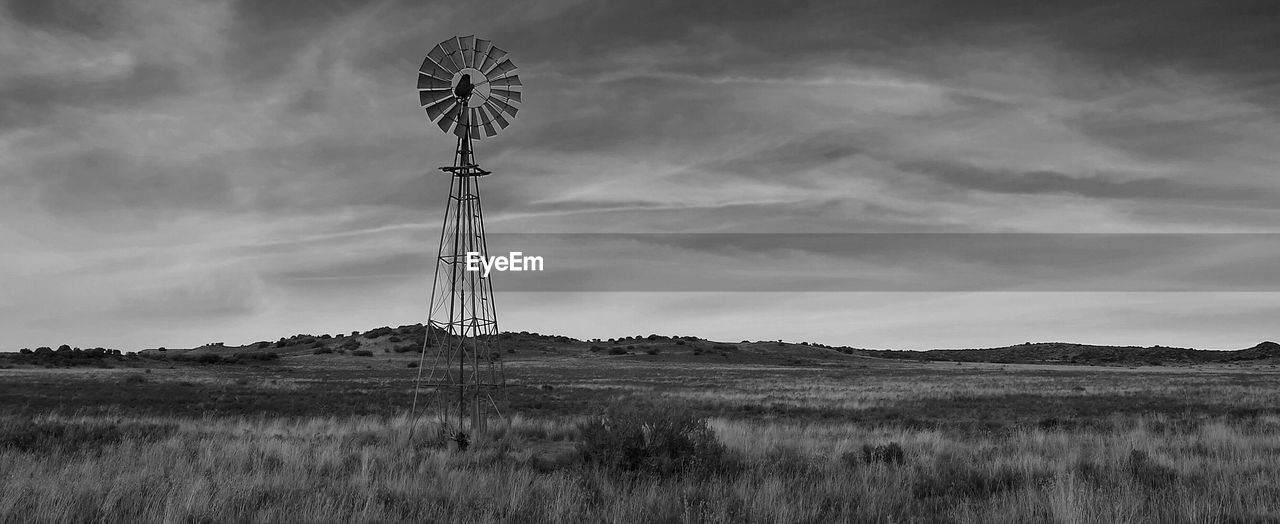 Windmill in field