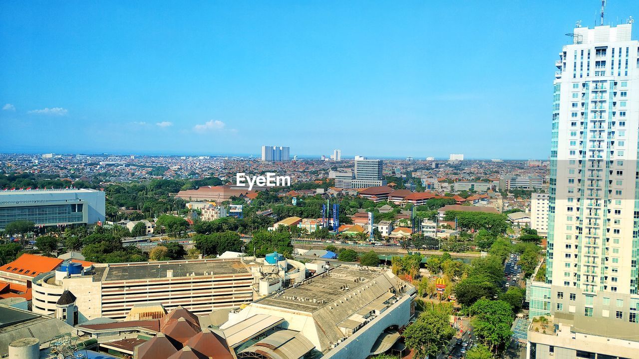 High angle view of townscape against blue sky