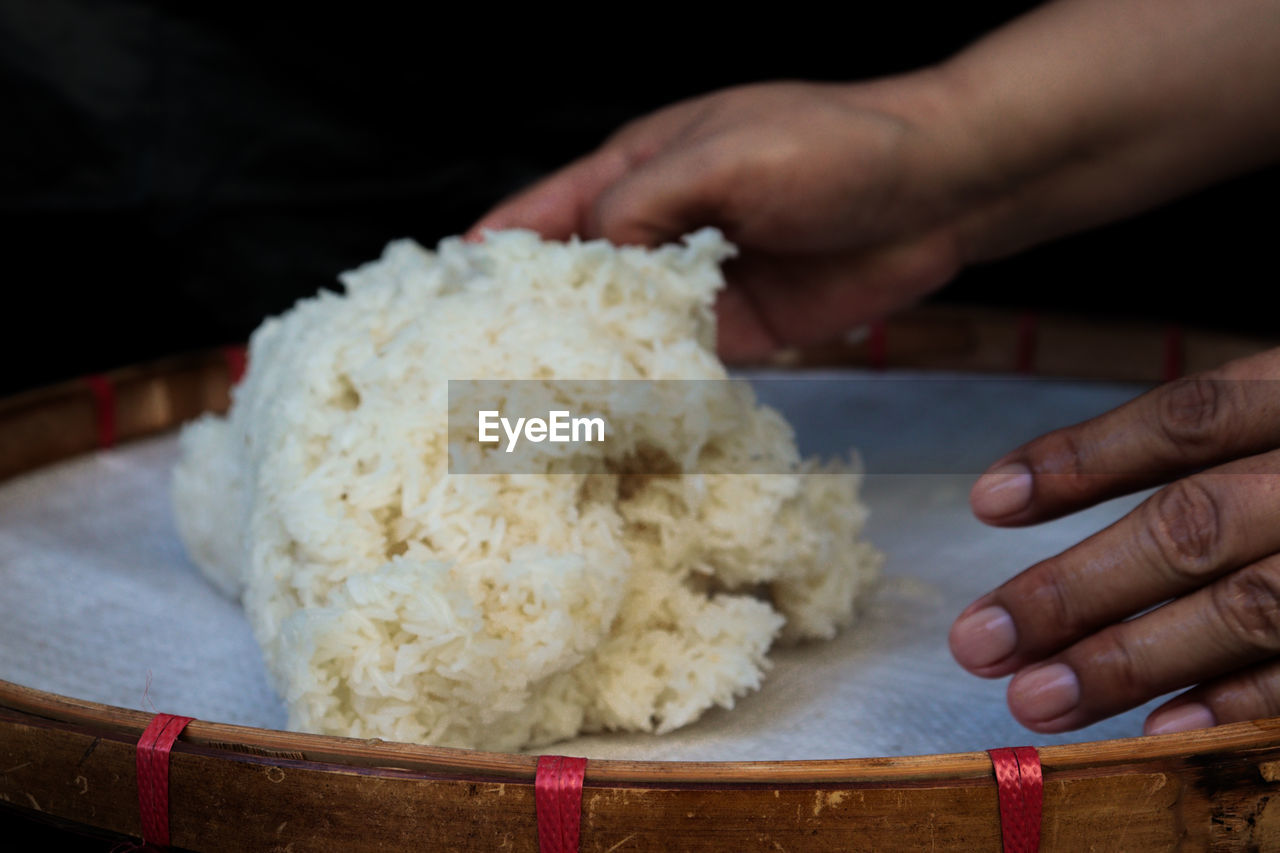 cropped hand of man preparing food