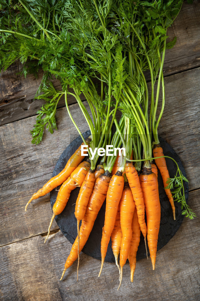 Healthy ripe juicy carrots on a wooden kitchen table. the concept of organic nutrition. 