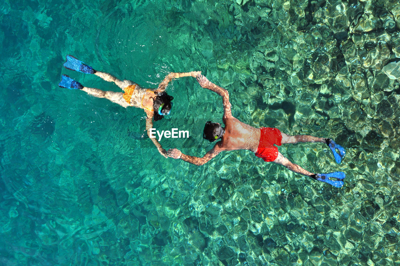 High angle view of people snorkeling in sea