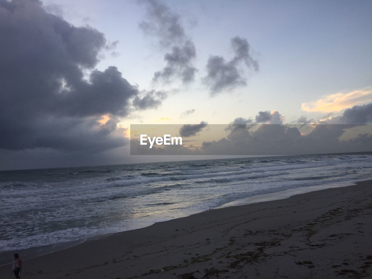 SCENIC VIEW OF BEACH DURING SUNSET