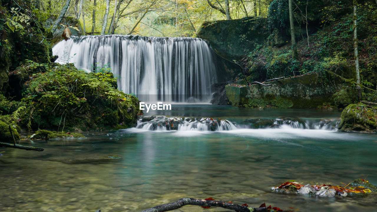 Scenic view of waterfall in forest. long exposure, stream, water.