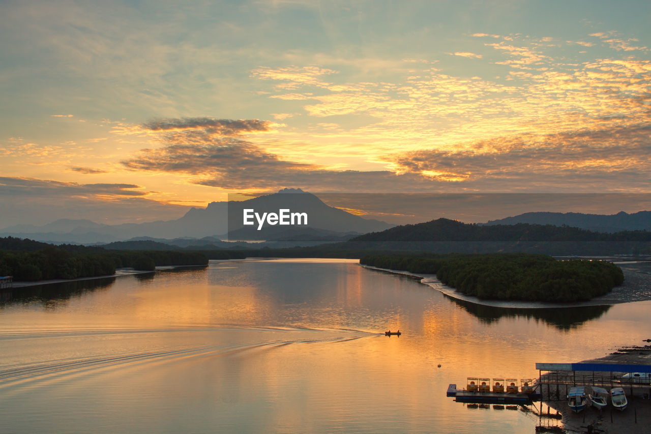 SCENIC VIEW OF LAKE AGAINST ORANGE SKY