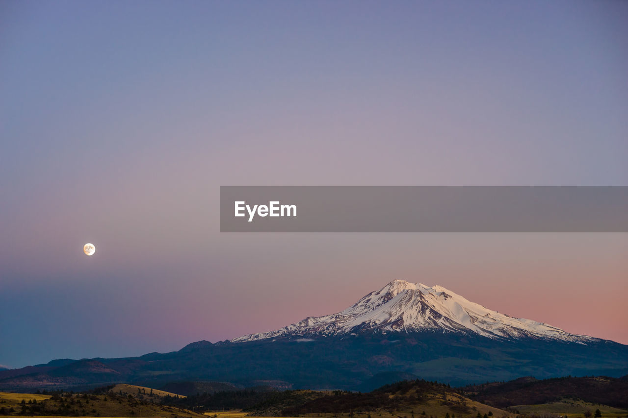 Scenic view of mountains against sky at night