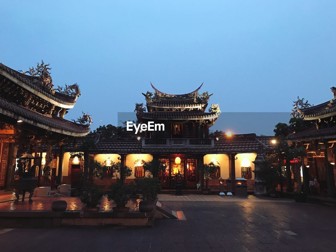 LOW ANGLE VIEW OF LIT TEMPLE AGAINST SKY