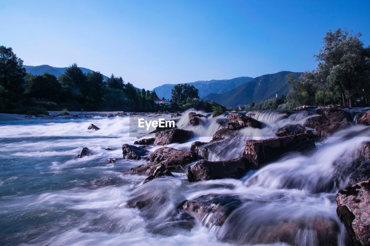 Scenic view of waterfall against clear sky