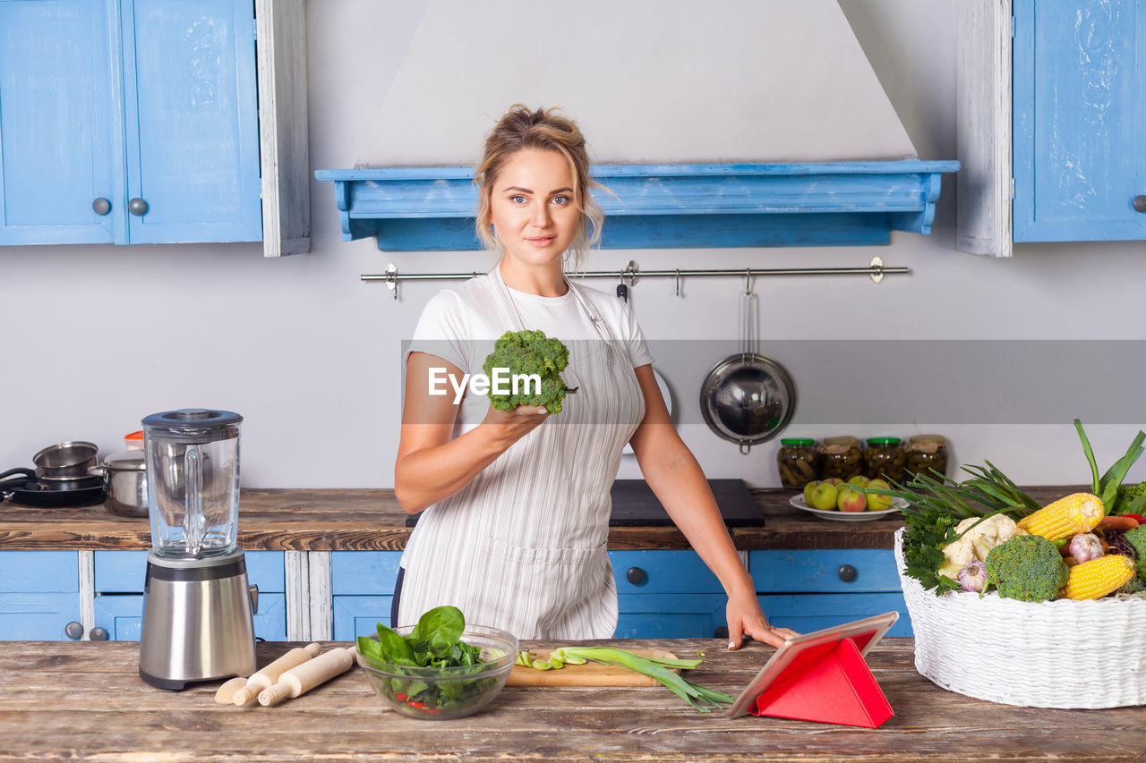 Full length of woman standing against plants