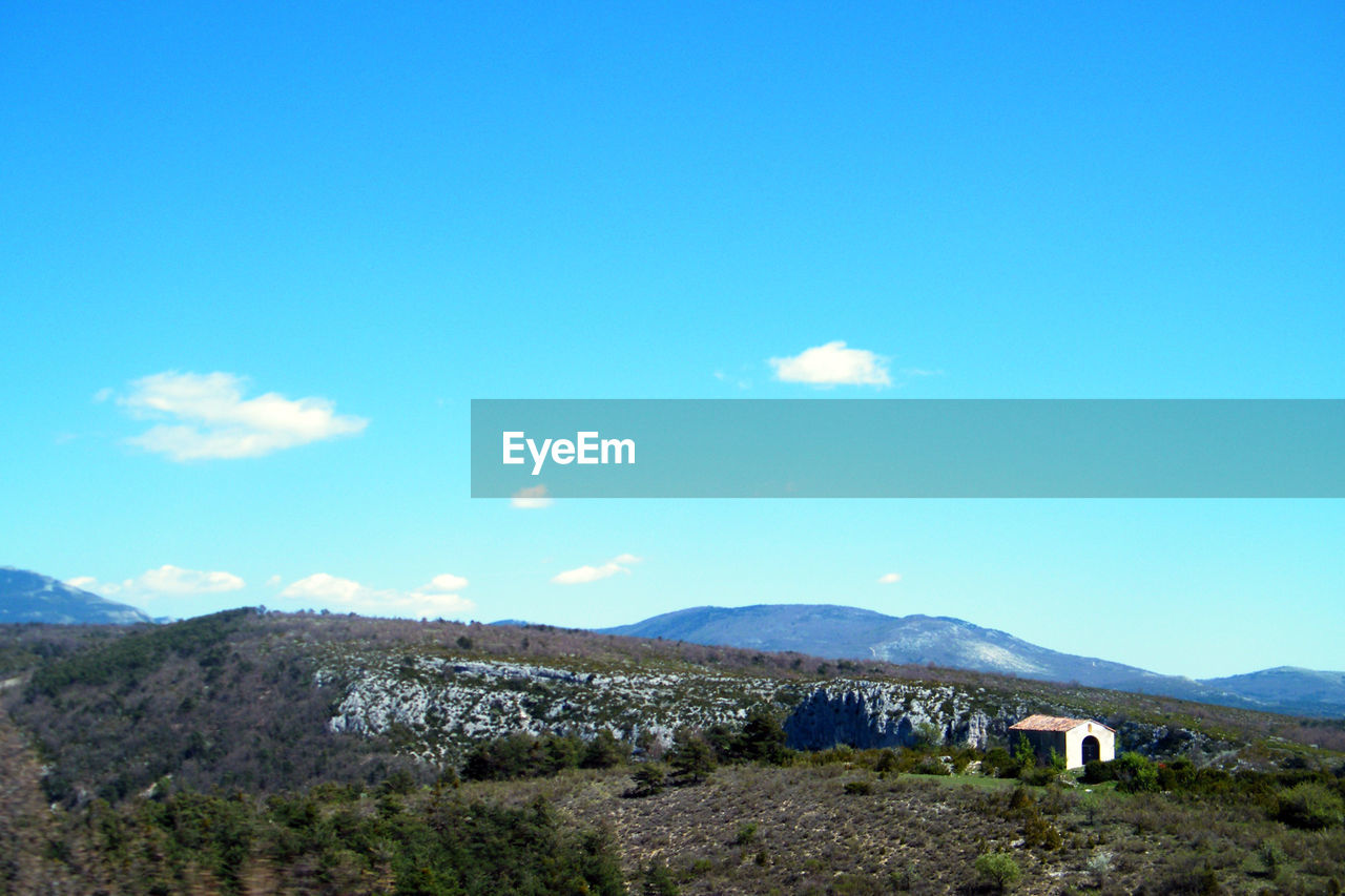 LANDSCAPE AGAINST BLUE SKY