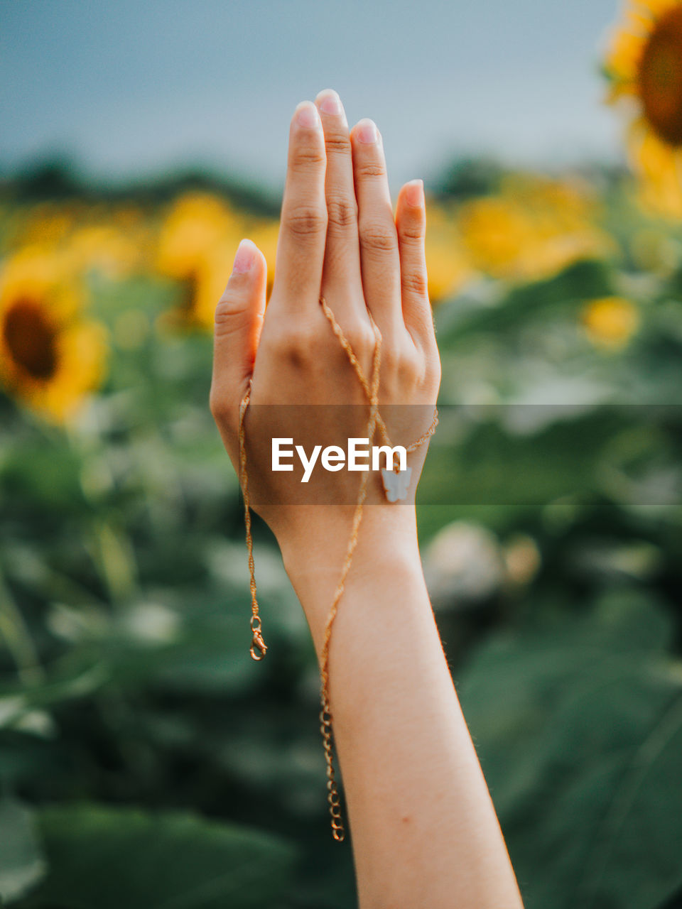 Cropped hand of woman with jewelry outdoors