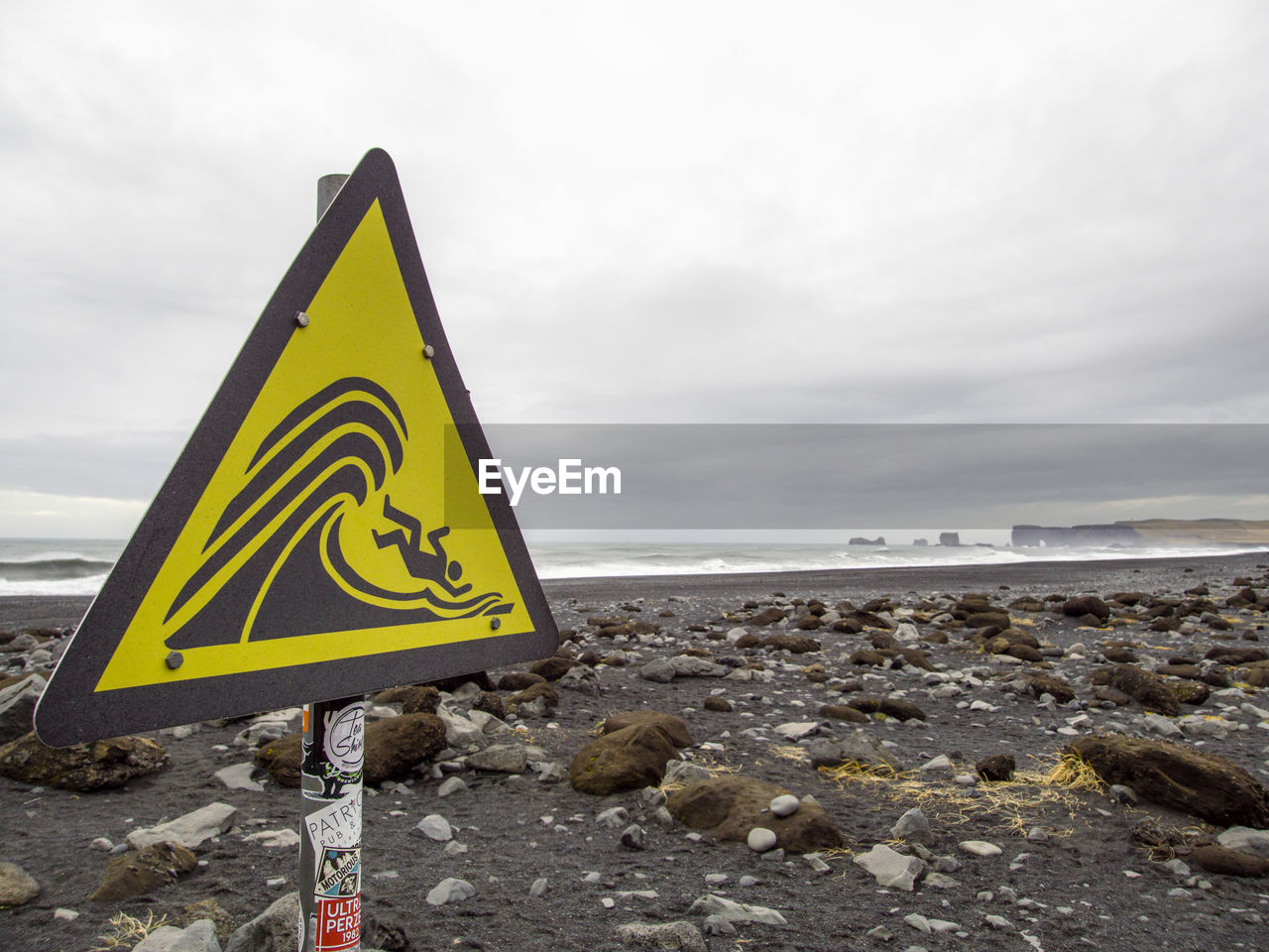 INFORMATION SIGN ON ROCK AGAINST SKY