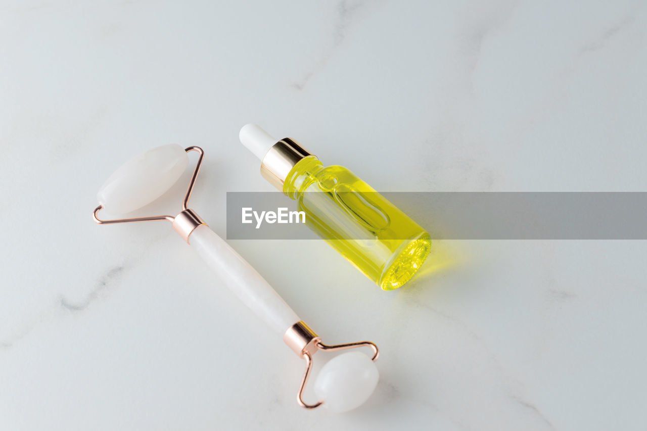 studio shot, indoors, glasses, hand, lighting, white background, yellow, still life, high angle view, copy space, lamp