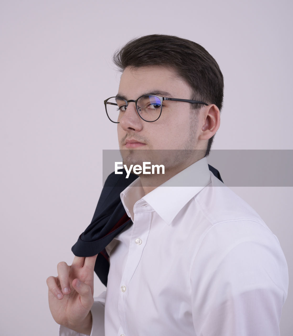 Close-up portrait of businessman against white background