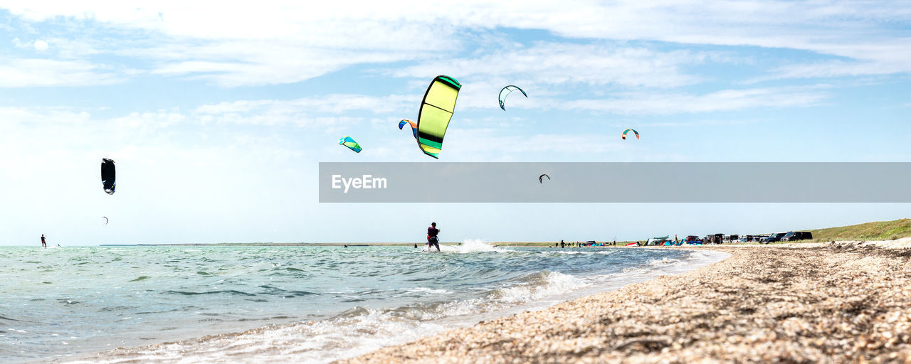 People on beach against sky