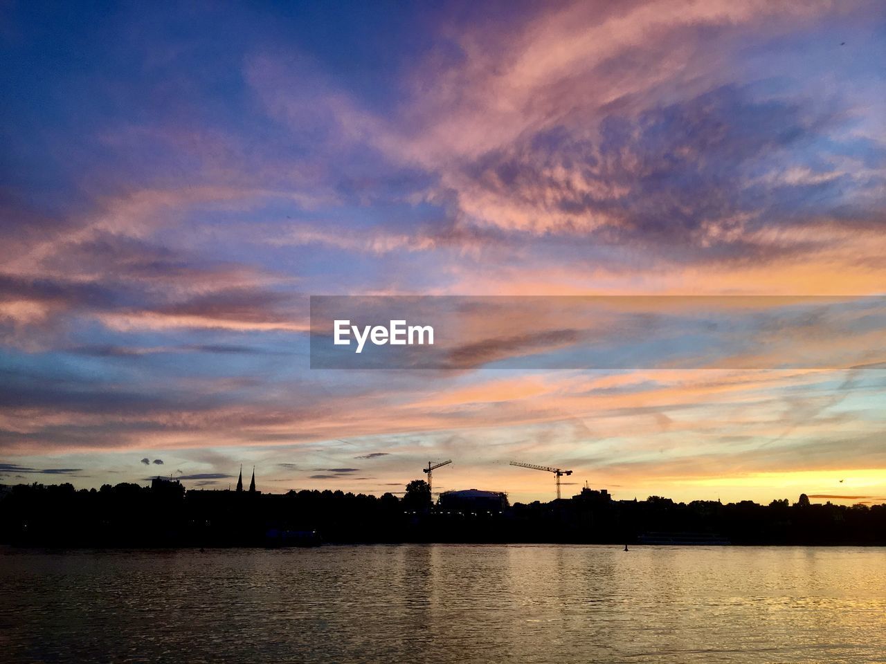 Scenic view of lake against sky during sunset