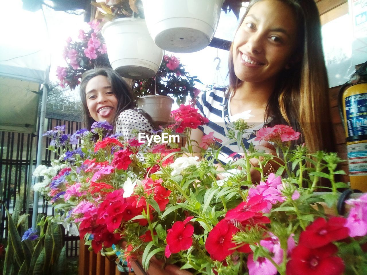 PORTRAIT OF HAPPY GIRL WITH FLOWERS