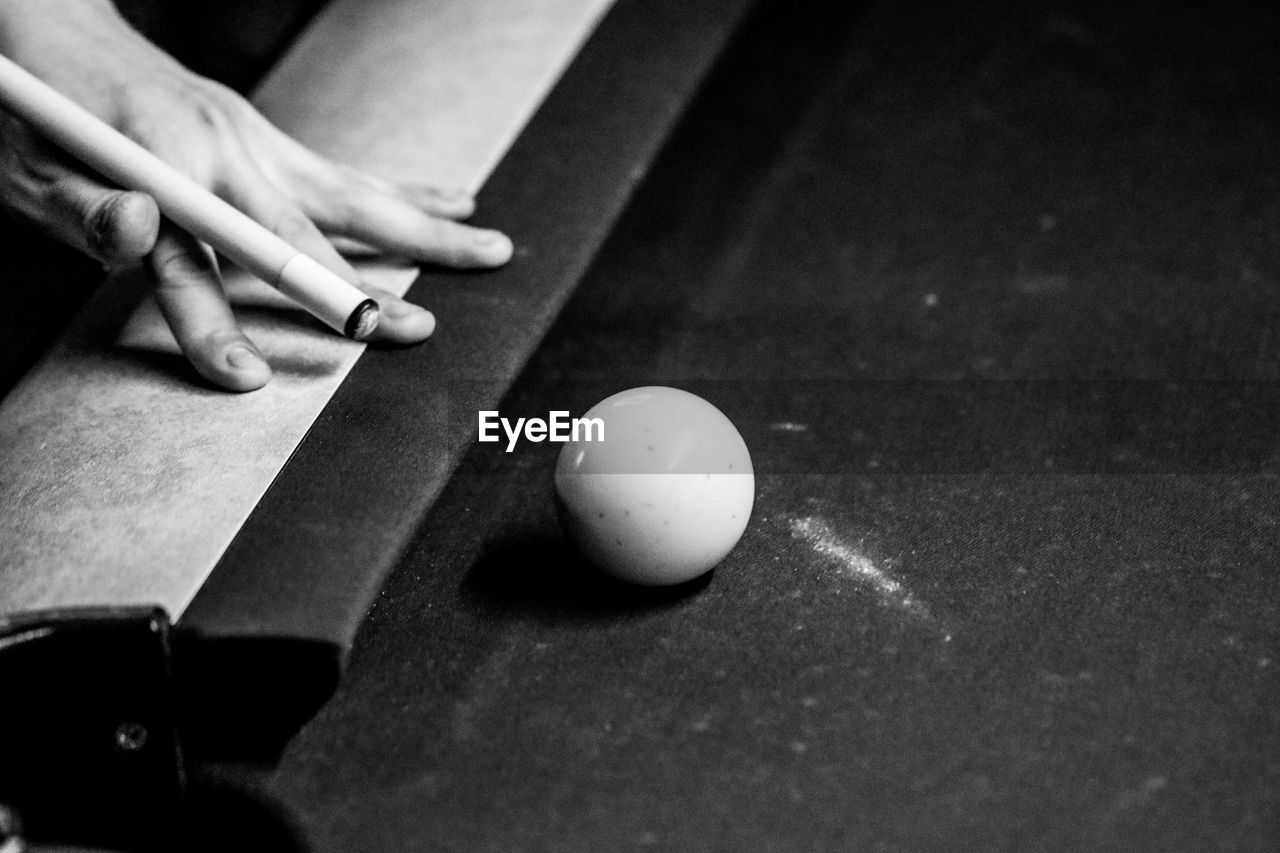 Cropped hand playing snooker 