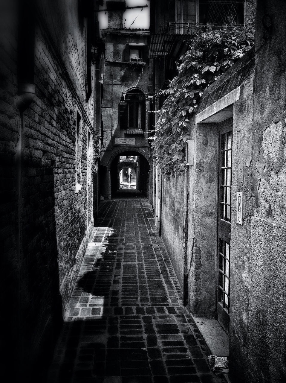 NARROW ALLEY WITH BUILDINGS IN BACKGROUND