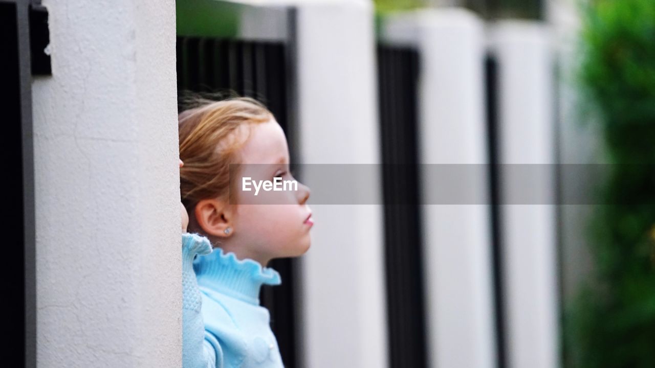 Cute girl looking away in city