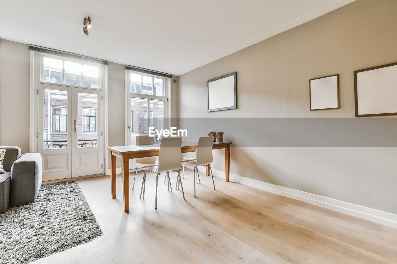 Empty chairs and table against wall at home