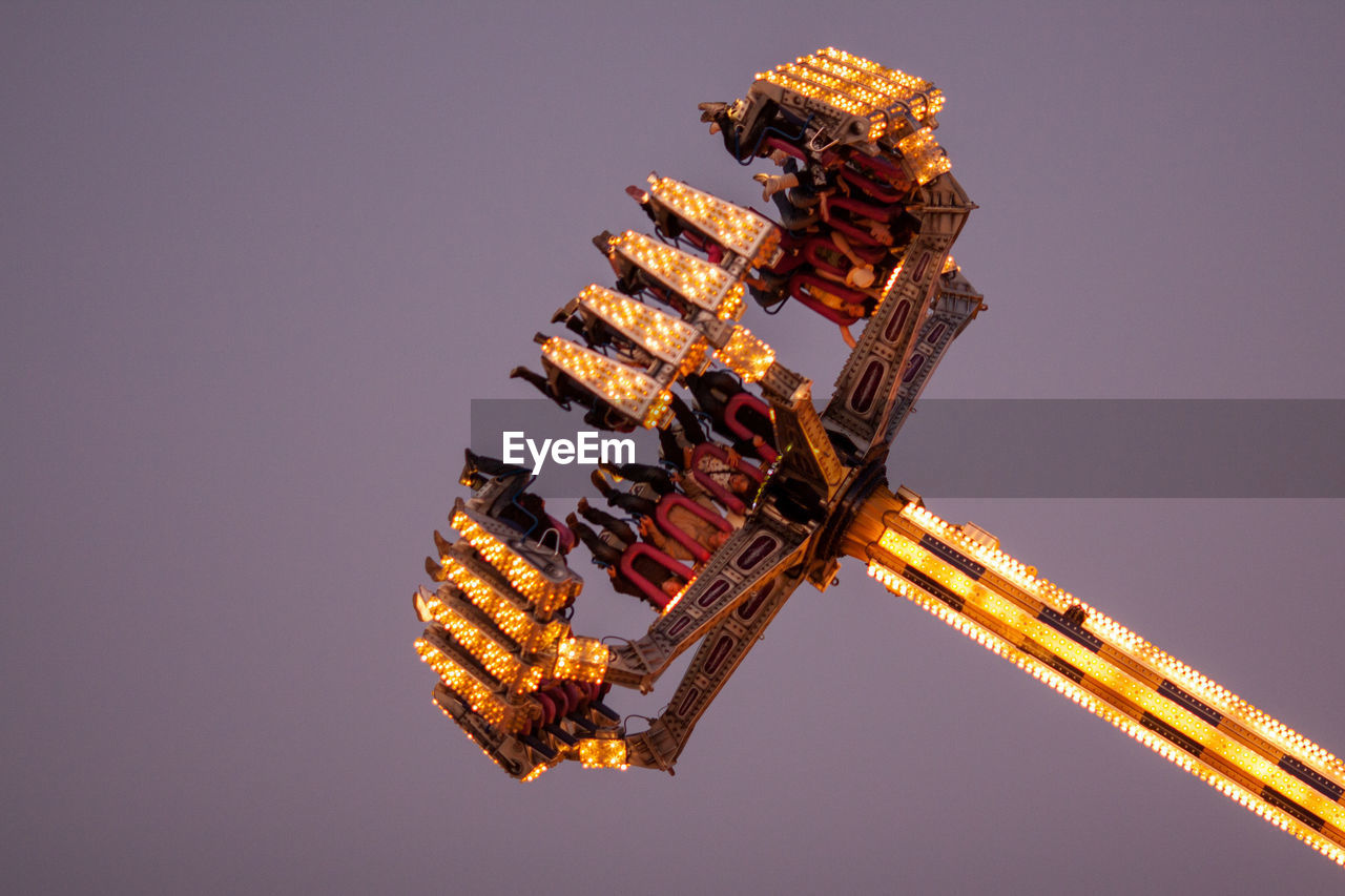 LOW ANGLE VIEW OF ILLUMINATED EIFFEL TOWER