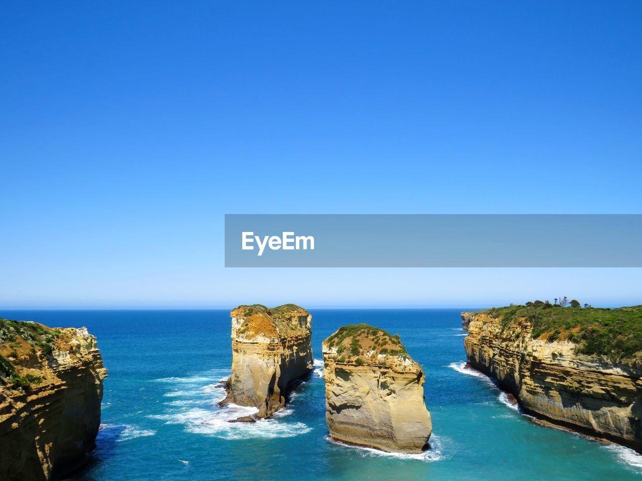 Scenic view of sea against clear blue sky