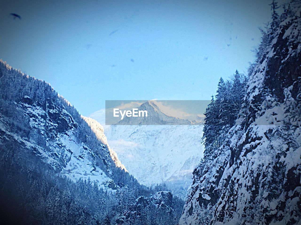 SNOWCAPPED MOUNTAINS AGAINST BLUE SKY