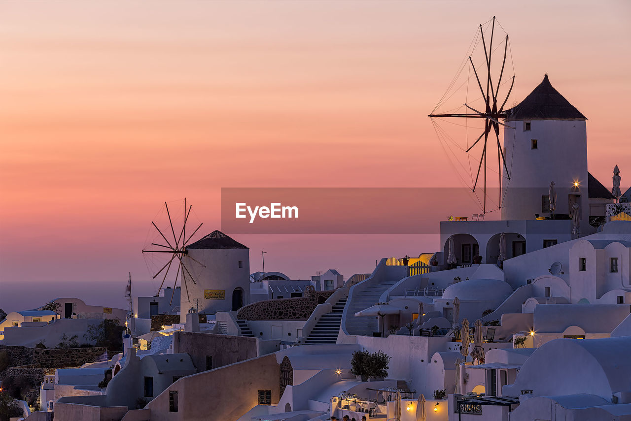 TRADITIONAL WINDMILL IN CITY AGAINST SKY