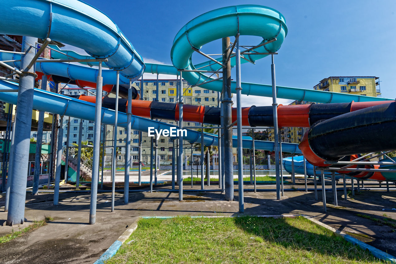 Metallic structure in playground against blue sky
