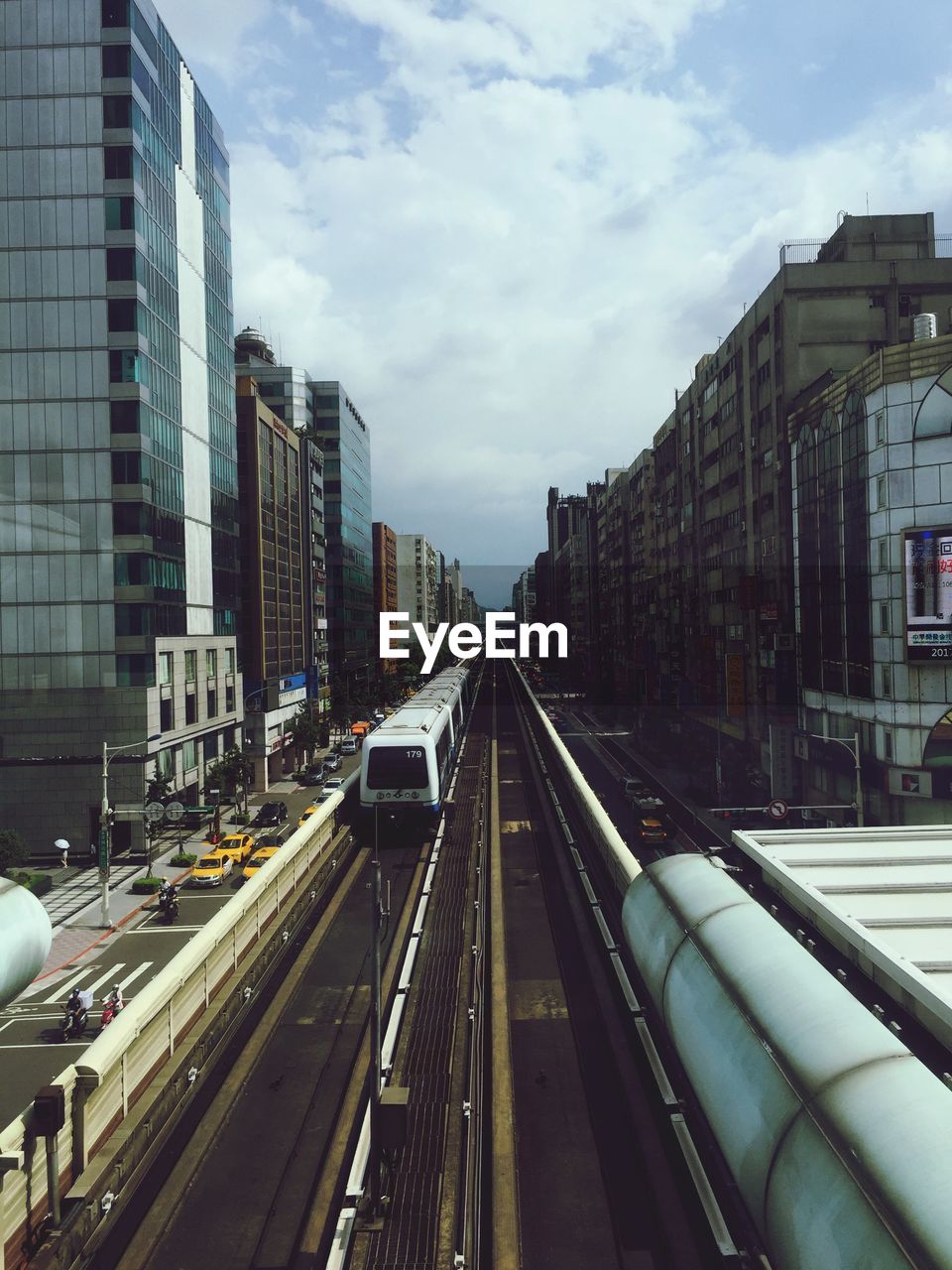 Railroad tracks in city against sky