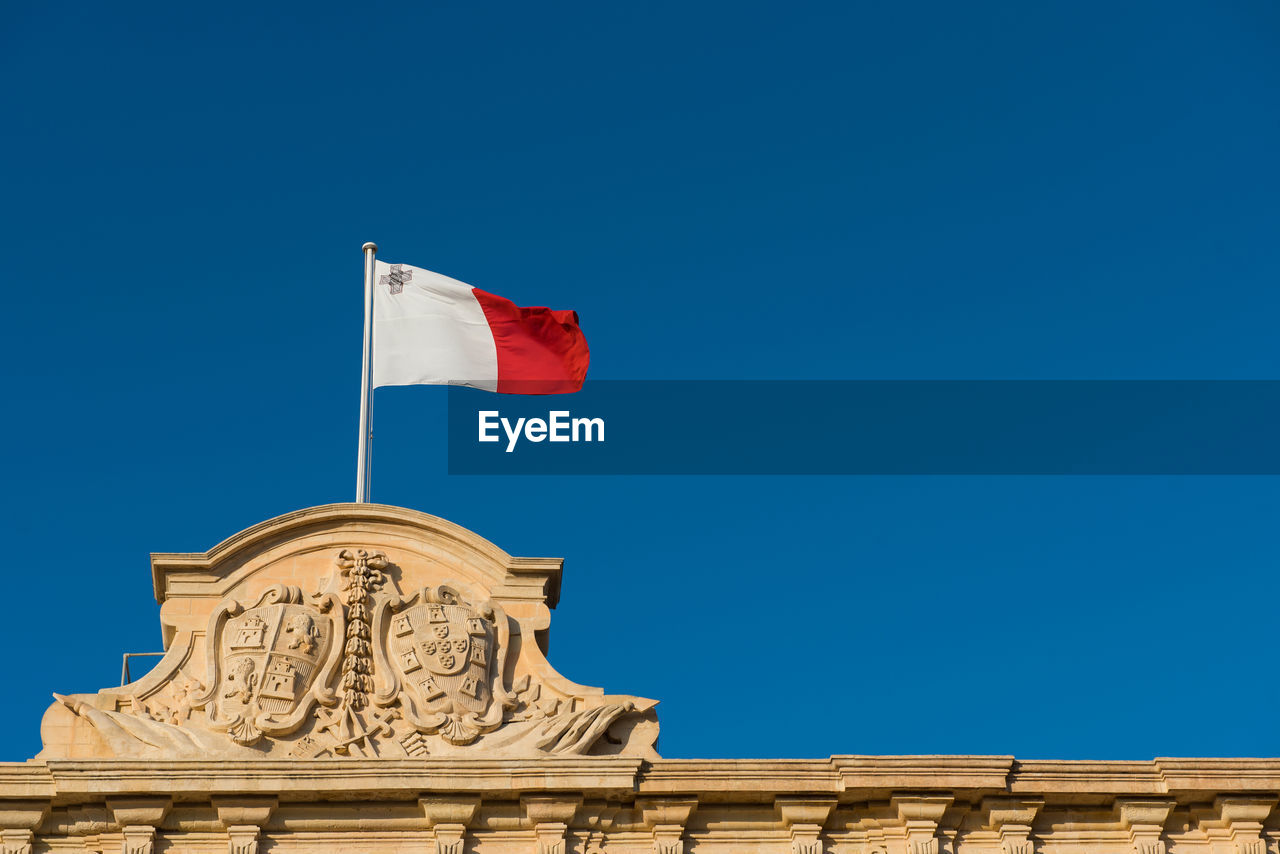 LOW ANGLE VIEW OF FLAG AGAINST BLUE SKY