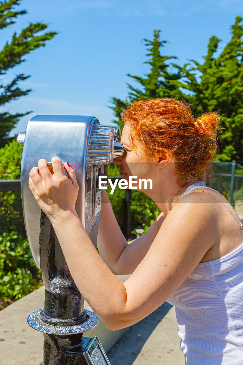 rear view of woman drinking water from bottle
