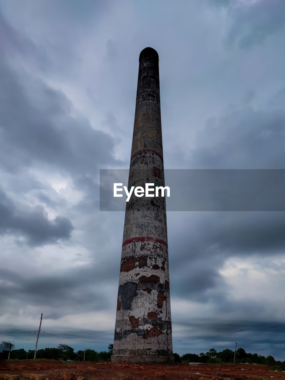 Low angle view of smoke stack against sky beautiful chimney brick kiln countryside of india 