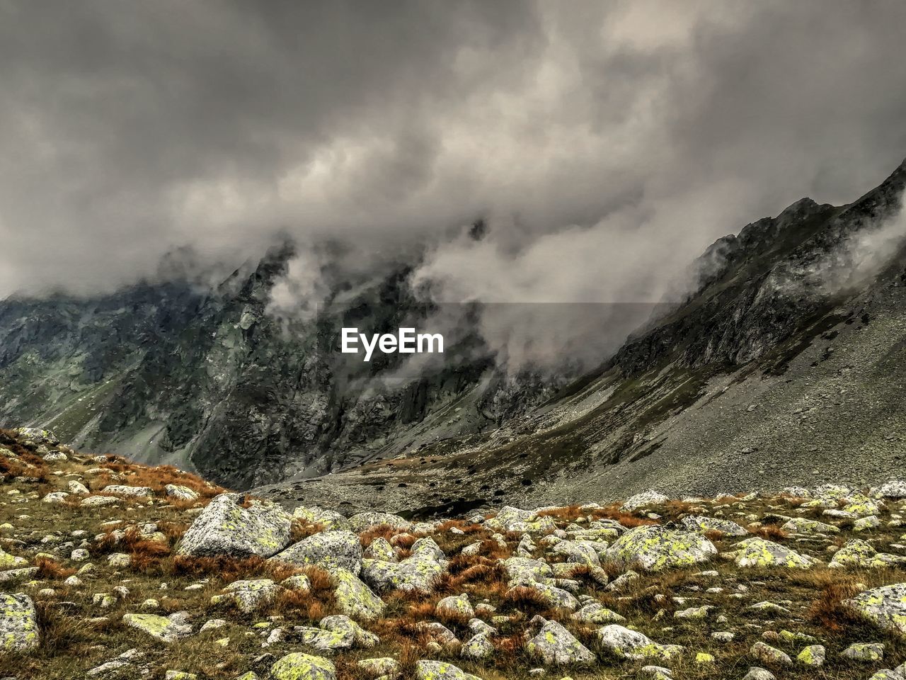 SCENIC VIEW OF MOUNTAINS AGAINST CLOUDY SKY