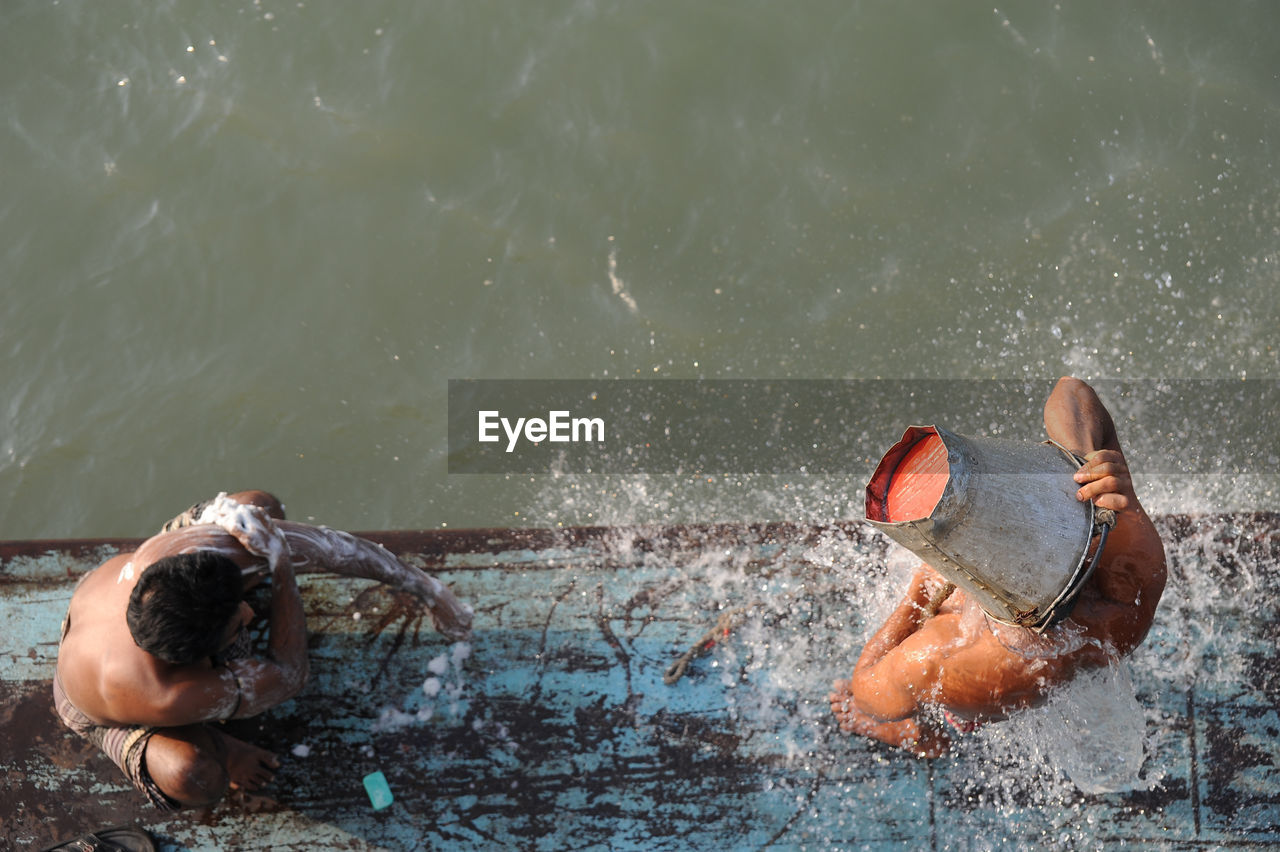 High angle view of people bathing at lakeshore