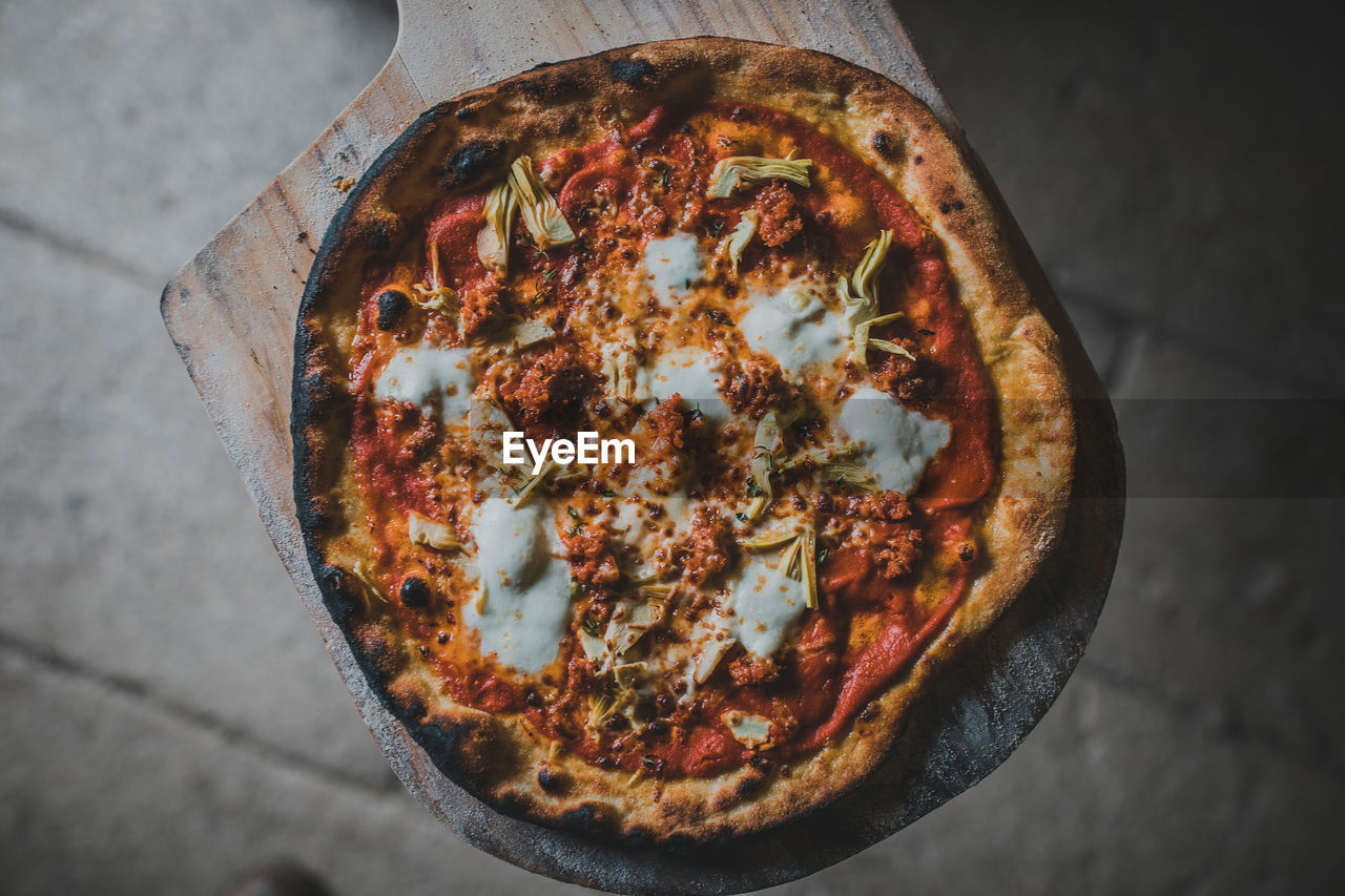 Directly above shot of pizza on cutting board