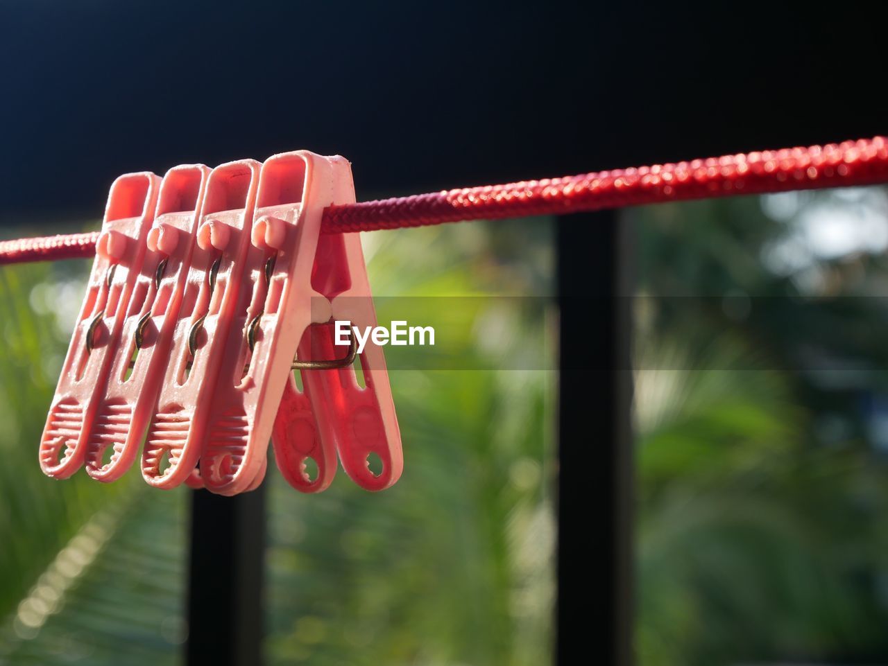 CLOSE-UP OF METAL HANGING ON ROPE