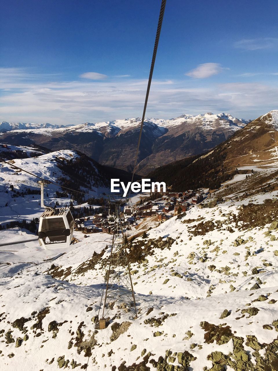 Overhead cable car against snowcapped mountains