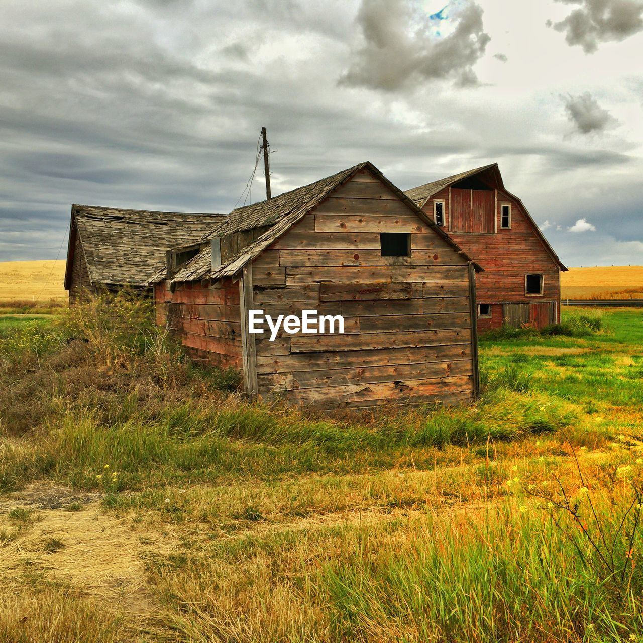 Abandoned house on field against sky