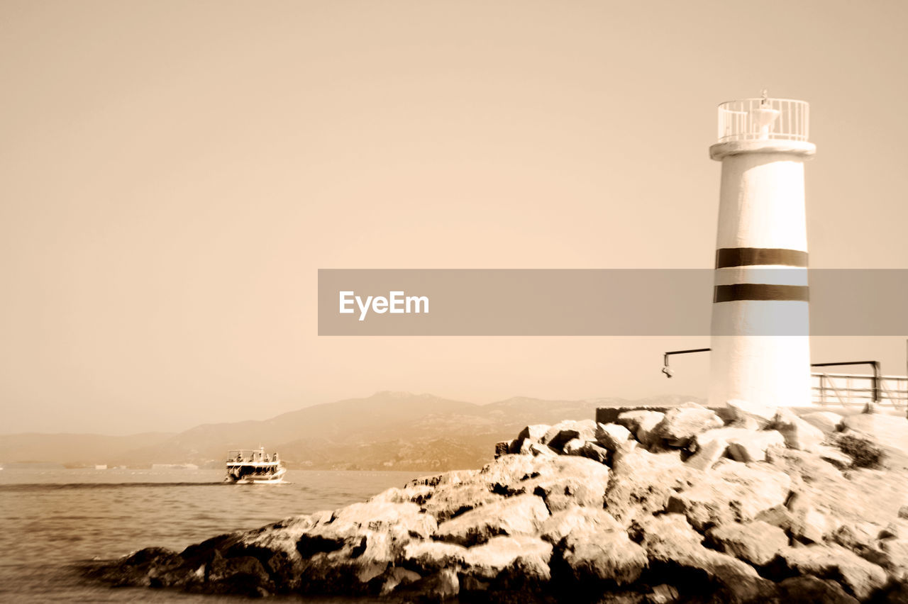 SCENIC VIEW OF SEA WITH MOUNTAIN IN BACKGROUND